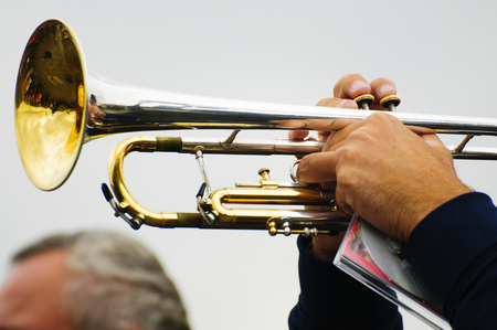 Brilliant ringing trumpet in the hands of the musicianの写真素材