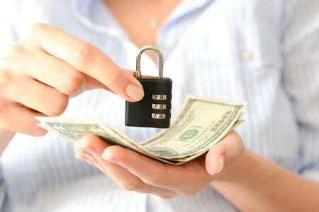 Saving protection concept with money and combination lockの写真素材