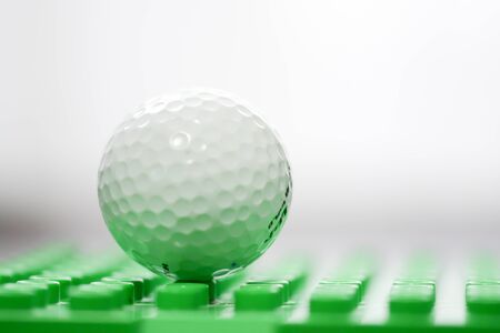 Macro shot of a golf ball on white backgroundの写真素材