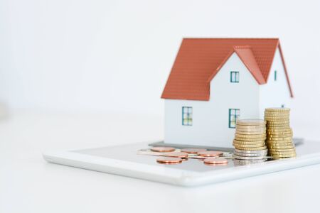 Digital tablet and house model on white backgroundの写真素材