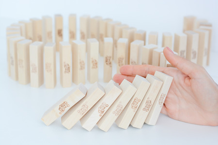 Stopping the domino effect concept with a business solution and interventionの写真素材