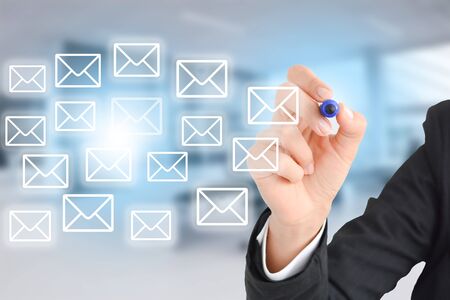 Business woman drawing e-mail messages in office conceptの写真素材