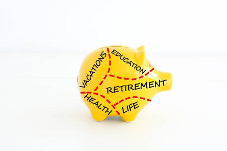 Retirement plan or savings concept with yellow piggy bankの写真素材