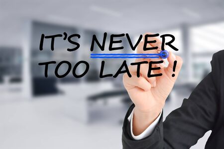It is never too late text with businesswoman hand writing on transparent backgroundの写真素材