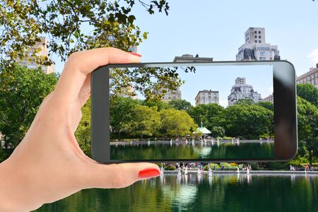 Tourist in Central Park of New York taking a shot of the beautiful landscapeの写真素材