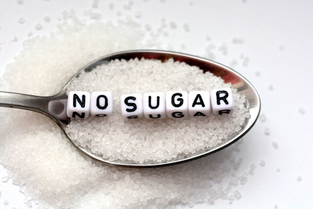 No sugar phrase made from plastic letter cubes placed in a spoon full of sugarの写真素材