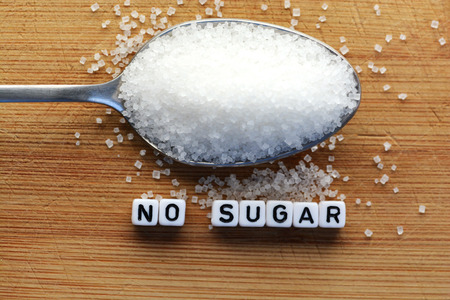 No sugar phrase made from plastic letter cubes placed in a spoon full of sugarの写真素材