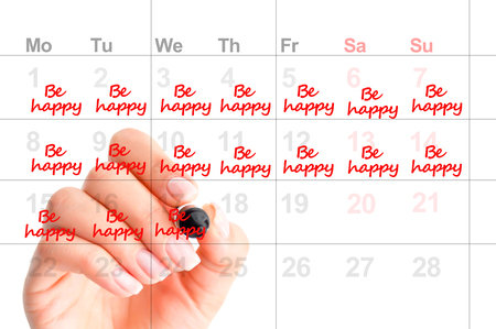 Writing in a calendar to be happy and to smile more as a wish for next year resolutionの写真素材