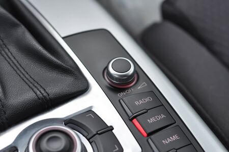 Car interior detail with close-up on multimedia buttonsの写真素材