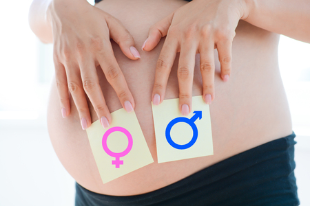 Boy or girl questions dilemma on pregnancy bellyの写真素材