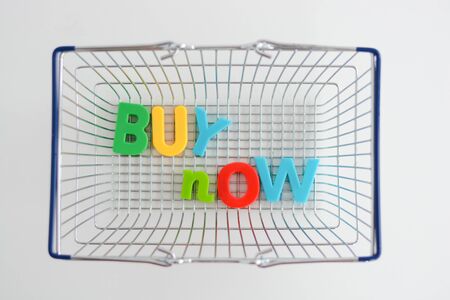 Buy now magnetic letters in a shopping basketの写真素材