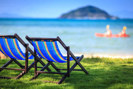 Chairs on beach at tropical island, Thailandの写真素材
