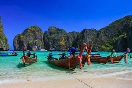 Long tail boat on white sand beach with crystal clear sea, Maya island, Krabi, Thailandのeditorial素材