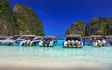 Speed boat on white sand beach with crystal clear sea, Maya island, Krabi, Thailandのeditorial素材