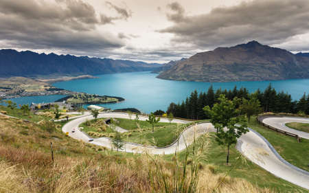 Luge track with beautiful lake and mountain at Skyline, Queenstown, New Zealandの写真素材