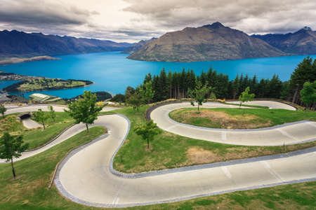 Luge track with beautiful lake and mountain at Skyline, Queenstown, New Zealandの写真素材