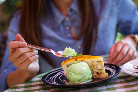 A woman cutting a piece of cake