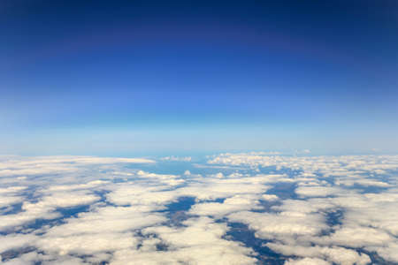 Aerial view fo city through airplane windowの写真素材