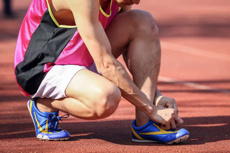 A runner man trying running shoes getting ready for joggingのeditorial素材