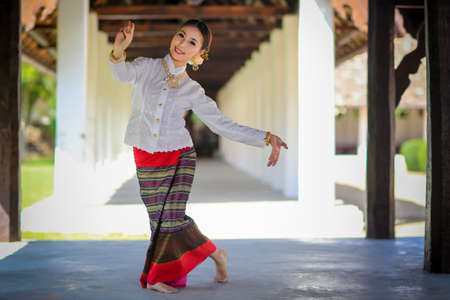 Thai dancing girl with northern style dress in temple, Chiang Mai, Thailandの写真素材