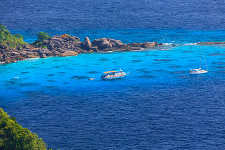 Aerial view of a beach with some motorboats in the turquoise sea, Similan island, Thailandの写真素材