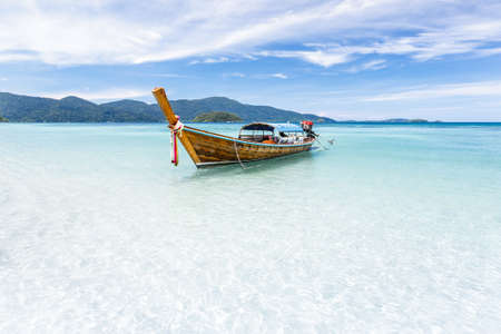 Long-tail boat floating on crystal clear sea water at tropical island, Andaman sea, Krabi, Thailandの写真素材