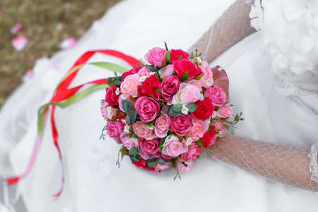 Bride with colorful bouquet, closeup, white wedding dressの写真素材
