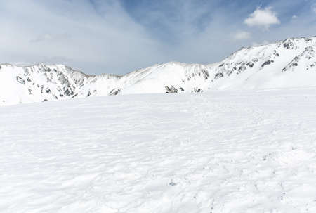 Rocks on the snow covered mountain under blue sky, Japanの写真素材