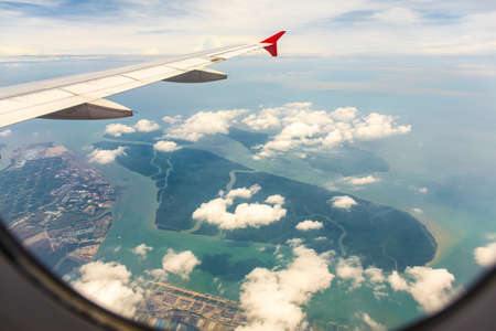 Clouds and sky as seen through window of an aircraftの写真素材