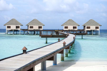 Water villas on crystal clear water at tropical island, Maldivesの写真素材