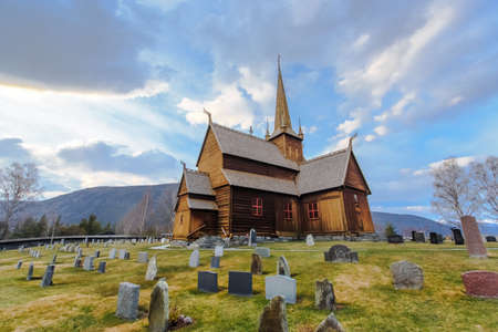 Lom stave church (Lom stavkyrkje) with graveyard foreground, Lom, Norway