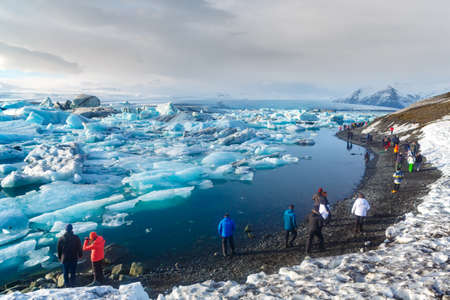 South Iceland - March 12, 2017. Tourist walking along glacier lagoon, Jokulsarlon, Icelandのeditorial素材