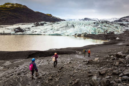 Group of hikers walking to glacier with guide, Icelandの写真素材