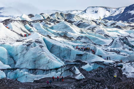 Private guide and group of hiker walking on glacier at Solheimajokull, Icelandのeditorial素材
