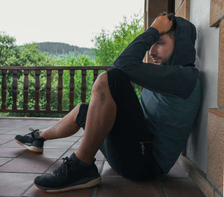 Young man in sportswear with hood onの写真素材