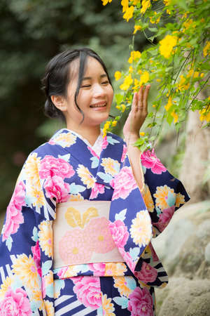 Tokyo, Japan- March 29,2019 a cute asian woman in japanese clothes is enjoy watching flowersのeditorial素材