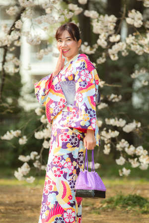 Tokyo,Japan- Mar 27,2019 : cute young asian woman in traditional japanese kimono enjoy sakura festival at shinjuku gyoen cherry blossom in springのeditorial素材