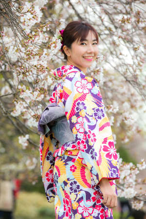 Tokyo,Japan- Mar 27,2019 : cute young asian woman in traditional japanese kimono enjoy sakura festival at shinjuku gyoen cherry blossom in springのeditorial素材