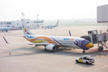 Bangkok, Thailand April  15, 2020 : commercial airplane is parking while a truck is passing at bangkok airport, Don mueang Thailandのeditorial素材