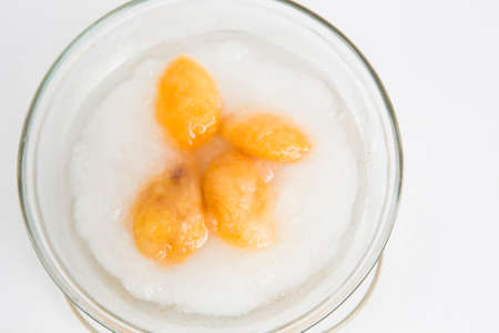 snake fruit in syrup with ice in a glass bowl, a thai dessert called 'sala loay klew'の写真素材