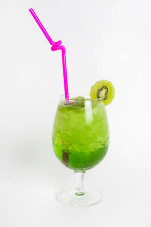 green kiwi drink with iced in a glass decorated with sliced kiwiの写真素材