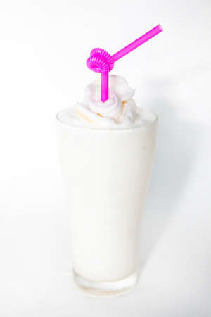 white drink coconut smoothie in a tall glass top with piece of coconut looks delicious and refreshingの写真素材