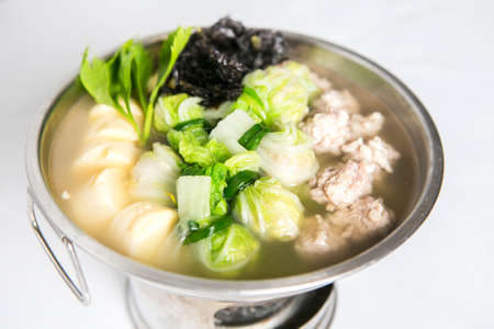 clear soup with tofu and minced pork chinese cabbage seaweed served in hot potの写真素材