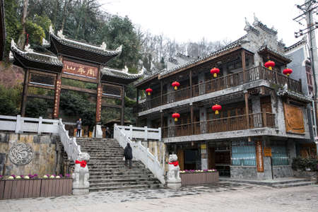 FengHuang, China Feb 21, 2014 ancient traditional chinese building decorated with red lantern and stairway leading to big chinese traditional gateのeditorial素材