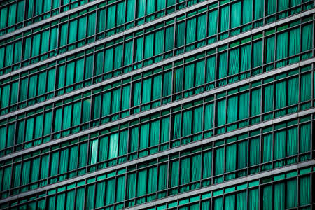 Bangkok, Thailand - 14 August, 2020 : pattern of green windows from outside the building