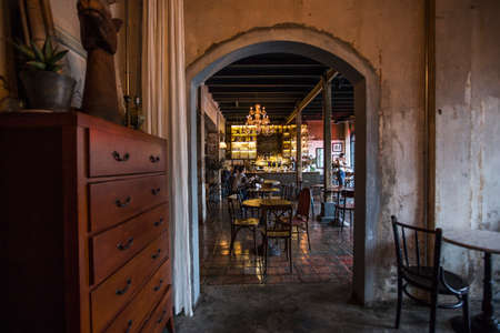 Bangkok, Thailand - 30 Sep 2020: rustic and vintage style cafe dirty wall and wooden cupboard wooden table and chairs with beautiful chandelier lightsのeditorial素材