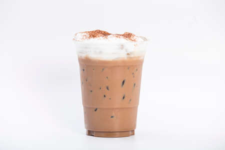iced mocha, coffee and cocoa powder mixed with sweetened condensed milk and fresh milk top with soft milk froth and cocoa powder in a takeaway plastic glass isolated white backgroundの写真素材