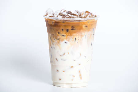 Cool iced latte coffee in a plastic glass isolated whiteの写真素材