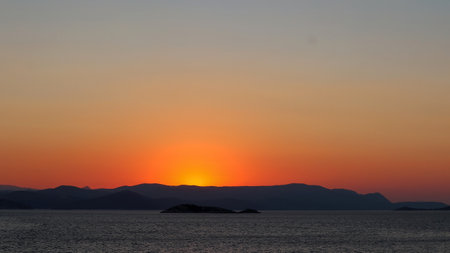 Sunset over the sea with islands in the background, Greece.の写真素材