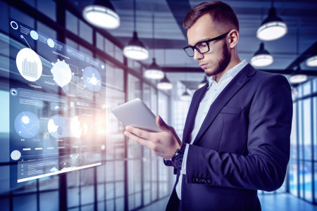 Confident public relations specialist with a tablet in hand, standing in front of a large screen displaying social media analyticsの素材